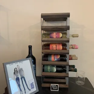 a bottle of wine and a picture of a woman