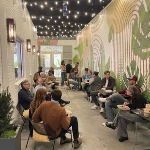 a group of people sitting in a restaurant
