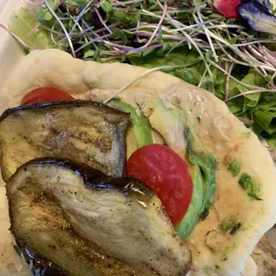 Eggplant sandwich w avocado and tomatoes was served with a fabulous salad of tender greens. $9.