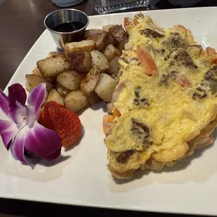 Create your own omelette with sausage, on, tomato, cheddar. Comes with potatoes, fruit, and pancakes.