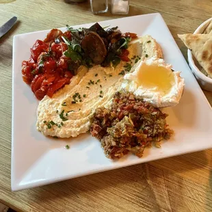 Hummus with roasted peppers, mushrooms, olive tapenade and goat cheese with Honey.