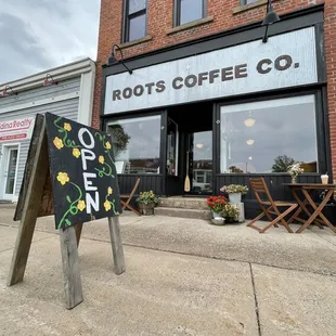 a sign in front of a coffee shop