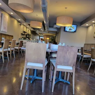 a dining room with a television and chairs