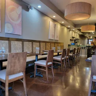 a dining area with tables and chairs