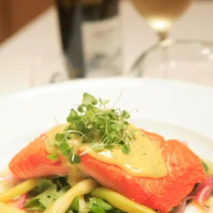 a plate of food and a glass of wine