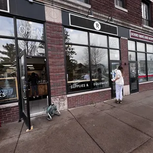 a woman standing in front of a store