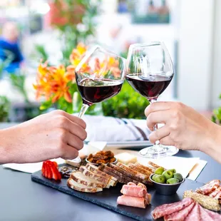 two people toasting with wine glasses