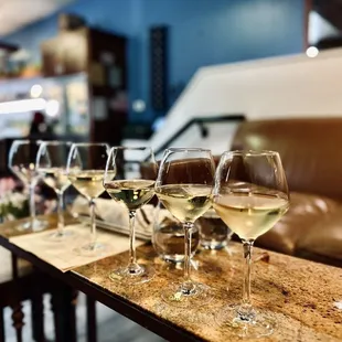 a row of wine glasses on a table