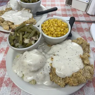 Chicken fried steaks, green beans and corn.