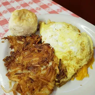 Ham and cheese omelet with with hashbrowns and biscuit.