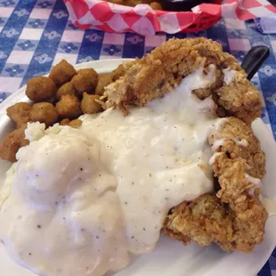 Chicken fried steak w/Oakra &amp; mashed potatoes w/ gravy. Fried pickles in the background