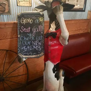 a statue of a cow in a red shirt