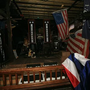 the interior of a house with american flags hanging from the ceiling