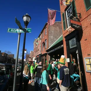 a crowd of people walking down the street