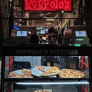 pizzas in a display case