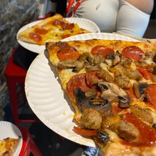 Hawaiian Pizza slice and a sausage, mushroom, pepperoni slice. And an extra pepperoni bc again. SO good.