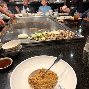 a group of people eating at a restaurant