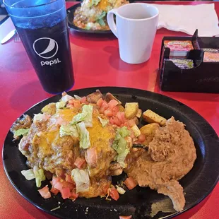 Breakfast chili rellano with scrambled eggs, refried beans, and smothered in green chili.
