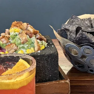 Strawberry margarita with sugar rim, fresh guacamole with pork belly, corn, and pico de gallo + their lovely blue corn chips!