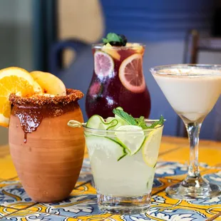 three cocktails on a table