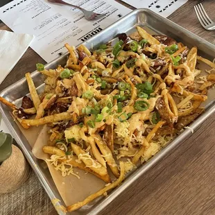 a tray of loaded fries on a table