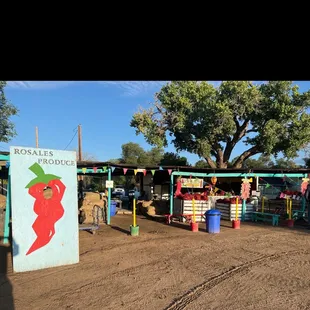 a fruit stand with a red chili on it