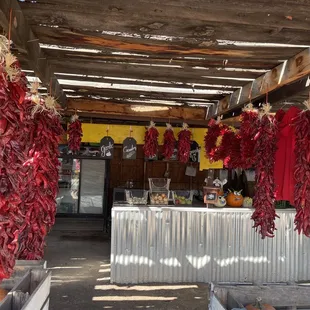 dried red peppers hanging from a roof