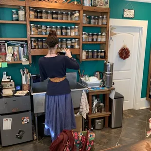 a woman preparing food in a kitchen
