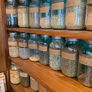 a shelf full of jars of spices