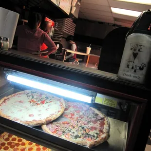 two pizzas on display