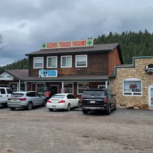 several vehicles parked in front of the store