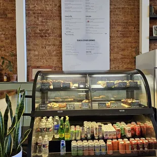 a deli counter with a variety of drinks