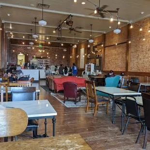 Unique cafe seating area with eclectic tables and chairs