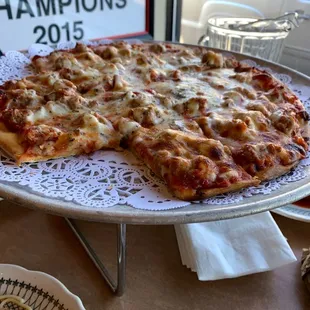 Thin crust cheese and sausage pizza