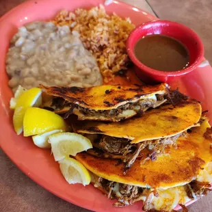 Birria Tacos served with rice and beans.