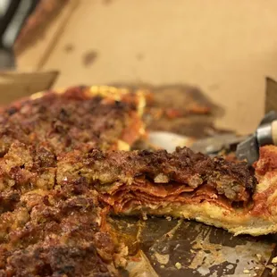 a partially eaten pizza in a box