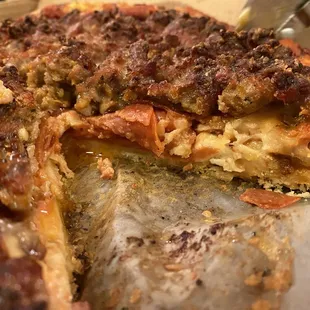 a deep dish pizza with a slice missing