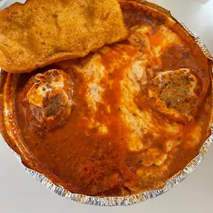 Lasagna with meatballs and garlic bread.