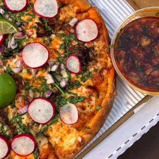 a pizza with radishes and lime