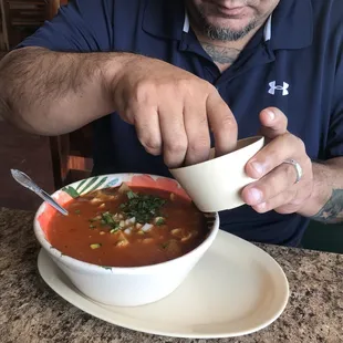 a man eating a bowl of soup
