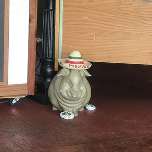 a small statue of a man wearing a sombren