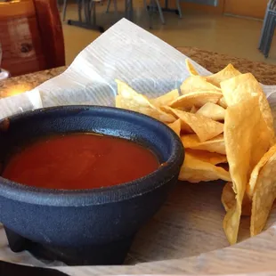 a bowl of salsa and chips