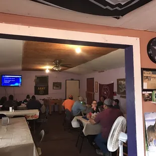 people sitting at tables in a restaurant