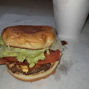 a hamburger with lettuce, tomato, and cheese
