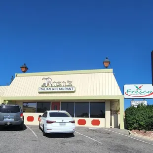 two cars parked in front of the restaurant