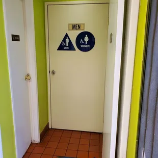 a bathroom door and a toilet
