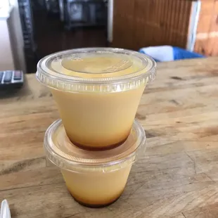 a close up of two plastic containers on a wooden table