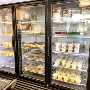 a display case filled with cupcakes