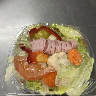 Small antipasto salad with dressing on the side