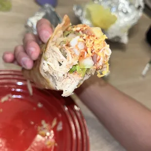 a person holding a sandwich